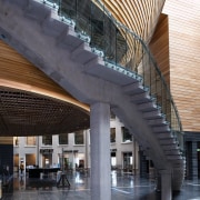 A view of the curved concrete staircase in architecture, building, daylighting, landmark, metropolitan area, mixed use, structure, tourist attraction, black, gray
