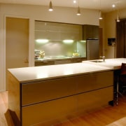 View of kitchen with light coloured countertop, and cabinetry, ceiling, countertop, floor, flooring, hardwood, interior design, kitchen, lighting, real estate, room, wood flooring, brown
