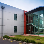 View of the sleek gass curved atrium at architecture, building, commercial building, corporate headquarters, facade, headquarters, house, mixed use, real estate, white