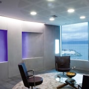 A view of soft ambient lighting supplied by architecture, ceiling, daylighting, floor, furniture, interior design, office, table, wall, gray