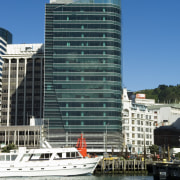 A view of an imaginative take on a architecture, boat, building, city, cityscape, commercial building, condominium, corporate headquarters, daytime, facade, harbor, headquarters, hotel, marina, metropolis, metropolitan area, mixed use, real estate, reflection, sky, skyline, skyscraper, tower block, urban area, water, water transportation, waterway, teal