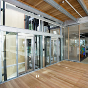 A view of the interior space of the architecture, ceiling, daylighting, door, facade, floor, flooring, glass, hardwood, house, interior design, laminate flooring, lobby, real estate, window, wood, wood flooring, brown, gray