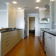 A view of the kitchen featuring solid bamboo cabinetry, ceiling, countertop, floor, flooring, hardwood, home, interior design, kitchen, laminate flooring, real estate, room, wood, wood flooring, gray, brown