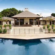 View of this outdoor pavillion that has a backyard, cottage, elevation, estate, facade, home, house, mansion, outdoor structure, property, real estate, residential area, resort, swimming pool, villa, white, teal