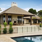 View of this outdoor pavillion that has a cottage, elevation, estate, facade, home, house, outdoor structure, property, real estate, resort, swimming pool, villa, brown, orange