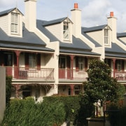 An exterior view of the domain terraces - architecture, building, cottage, estate, facade, historic house, home, house, mansion, neighbourhood, outdoor structure, property, real estate, residential area, roof, siding, suburb, tree, window, white