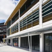 A view of extensive use of elliptical louvres architecture, building, commercial building, corporate headquarters, facade, mixed use, real estate, window, white