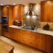 A view of frameless cabinets in alder, with cabinetry, countertop, cuisine classique, flooring, interior design, kitchen, room, under cabinet lighting, brown, orange