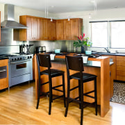 A view of this kitchen featuring stained timber cabinetry, countertop, cuisine classique, floor, flooring, hardwood, interior design, kitchen, laminate flooring, room, wood, wood flooring, white, orange