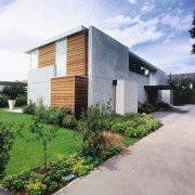 Exterior view of this contemporary home featuring thermomass architecture, facade, home, house, property, real estate, residential area, white