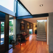 A view of the internal halways featuring  architecture, ceiling, floor, flooring, hardwood, house, interior design, living room, real estate, wood, wood flooring, black