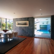 A interior view of the dining area featuring architecture, ceiling, daylighting, floor, flooring, hardwood, house, interior design, laminate flooring, living room, loft, real estate, room, wood, wood flooring, gray, brown