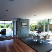 A interior view of the dining area featuring architecture, ceiling, daylighting, floor, flooring, hardwood, house, interior design, living room, real estate, window, wood flooring, gray