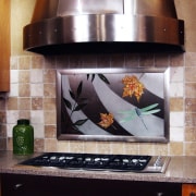 A view of this modern kitchen designed by countertop, gray, black