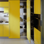 View of this clean lined kitchen featuring bright angle, architecture, furniture, interior design, kitchen, product design, shelf, shelving, yellow, gray, black