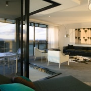 A view of the interior living spaces of architecture, house, interior design, living room, penthouse apartment, real estate, room, window, black