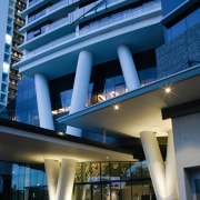 View of the steel columns that slice through apartment, architecture, building, commercial building, condominium, corporate headquarters, daytime, facade, headquarters, hotel, metropolitan area, mixed use, real estate, sky, skyscraper, blue