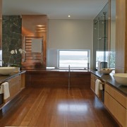 A view of the master ensuite featuring stained cabinetry, countertop, floor, flooring, hardwood, interior design, kitchen, room, window, wood, wood flooring, brown, gray
