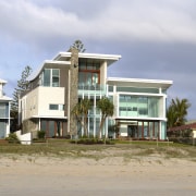 Exterior view of the solid masonry beachfront house apartment, architecture, building, cloud, condominium, facade, home, house, property, real estate, residential area, sky, gray
