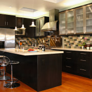 View of this kitchen featuring stained timber flooring, cabinetry, countertop, cuisine classique, interior design, kitchen, room, black, brown
