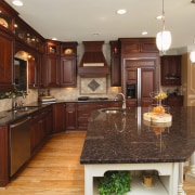 A view of this kitchen featuring custom cherry cabinetry, countertop, cuisine classique, interior design, kitchen, room, brown, red