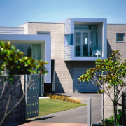 Exterior view of the house designed by Dalman architecture, building, condominium, corporate headquarters, elevation, facade, home, house, neighbourhood, property, real estate, residential area, siding, window, teal, gray