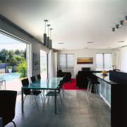 A view of the kitchen and dining area architecture, ceiling, daylighting, dining room, floor, furniture, house, interior design, real estate, table, white