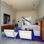 A view of the living area featuring white ceiling, interior design, living room, real estate, room, table, gray