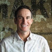 A view of John Mills, Architect - A elder, facial expression, human, person, photograph, portrait, senior citizen, smile, temple, brown, black