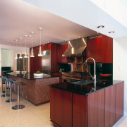 A view of this kitchen featuring terrazzo flooring, cabinetry, ceiling, countertop, cuisine classique, interior design, kitchen, red