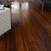 A view of these living areas featuring polished floor, flooring, furniture, hardwood, interior design, laminate flooring, living room, table, wood, wood flooring, wood stain, brown, gray