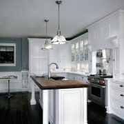 A view of this white kitchen featuring traditional cabinetry, countertop, cuisine classique, home appliance, interior design, kitchen, gray