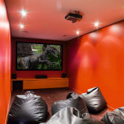 A view of an home theatre system witch ceiling, home, interior design, orange, room, wall, red