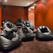 A view of an home theatre system witch couch, furniture, room, red