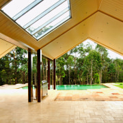 A view of some stone pavers treated with architecture, daylighting, estate, home, house, outdoor structure, property, real estate, roof, window, wood, orange, brown