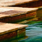 A view of some stone pavers treated with lumber, reflection, table, water, wood, wood stain, orange