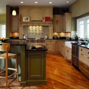 View of this traditional kitchen featuring grean teak cabinetry, countertop, cuisine classique, floor, flooring, hardwood, interior design, kitchen, laminate flooring, room, wood flooring, brown