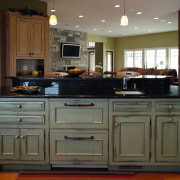 View of this traditional kitchen featuring grean teak cabinetry, countertop, cuisine classique, furniture, hardwood, kitchen, room, gray, brown, black