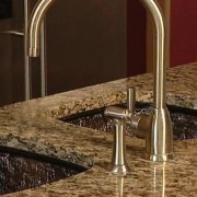 A view of this kitchen featuring a JSG countertop, plumbing fixture, sink, tap, brown