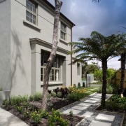 A view of a home designed by Town architecture, building, cottage, estate, facade, home, house, neighbourhood, property, real estate, residential area, sky, tree, villa, walkway, window, gray