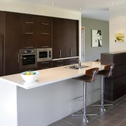 A view of a home designed and built cabinetry, countertop, cuisine classique, floor, furniture, interior design, kitchen, property, real estate, room, gray, black