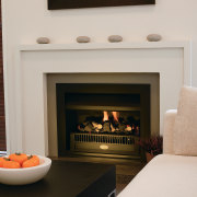 A view of s fireplace from Fires By fireplace, hearth, home, interior design, living room, room, wood burning stove, gray