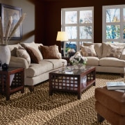 A view of these living spaces featuring sisal carpet, couch, floor, flooring, furniture, hardwood, home, interior design, laminate flooring, living room, loveseat, room, table, wood, wood flooring, red