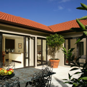 A view of this home is designed for courtyard, estate, facade, hacienda, home, house, property, real estate, villa, window, black