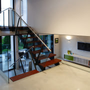 A view of the staircase featuring stainless steel floor, flooring, handrail, house, interior design, loft, stairs, orange