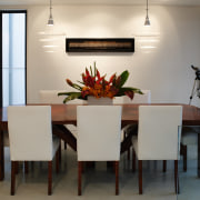 A view of the dining area featuring stained dining room, furniture, interior design, room, table, gray