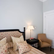 A view of this bedroom featuring carpet flooring, bed frame, bedroom, ceiling, floor, flooring, home, interior design, living room, real estate, room, suite, wall, wood, gray