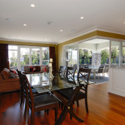 A view of a home designed and built ceiling, dining room, estate, floor, flooring, hardwood, home, interior design, living room, property, real estate, room, window, wood flooring, gray