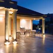 A view of some electrical work done by backyard, column, estate, evening, home, landscape lighting, lighting, outdoor structure, patio, property, real estate, sky, swimming pool, villa, blue