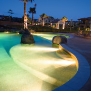 A view of some electrical work done by evening, leisure, light, lighting, reflection, sky, swimming pool, tree, water, water feature, water resources, blue